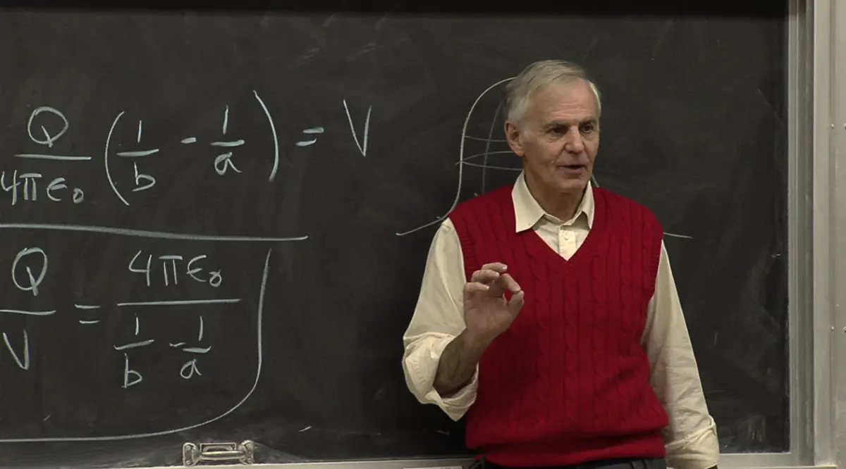 Robert H. Lieberman teaching physics at a chalkboard covered in capacitance equations